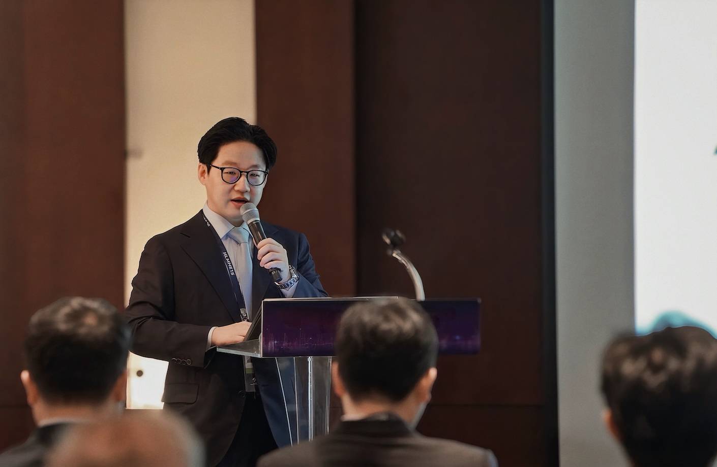 Lunit CEO, Brandon Beomseok Suh speaking at a podium.